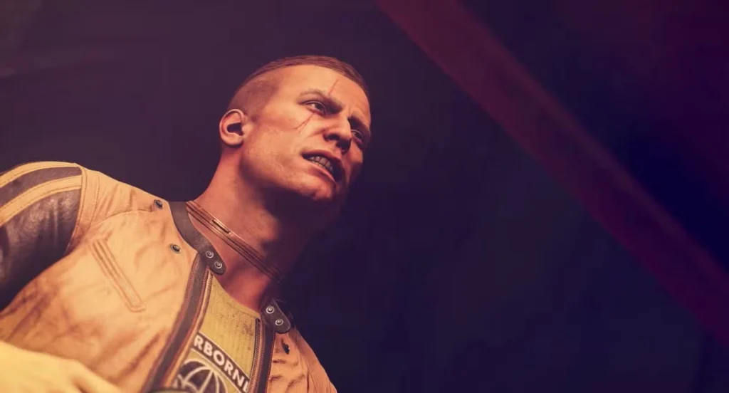 Cena do jogo Wolfenstein mostrando protagonista em close dramático, ambientação sombria com iluminação quente, representando a adaptação da franquia e a diferença entre adaptar Fallout e Wolfenstein para TV. Image: MachineGames/Bethesda Softworks