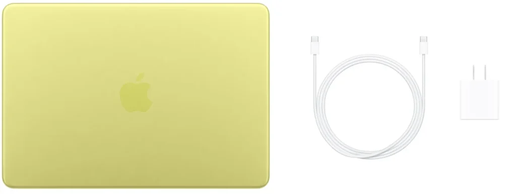 MacBook Neo amarelo visto por cima ao lado do carregador USB-C de 20W e cabo de carregamento incluído na caixa do laptop de 13 polegadas da Apple.